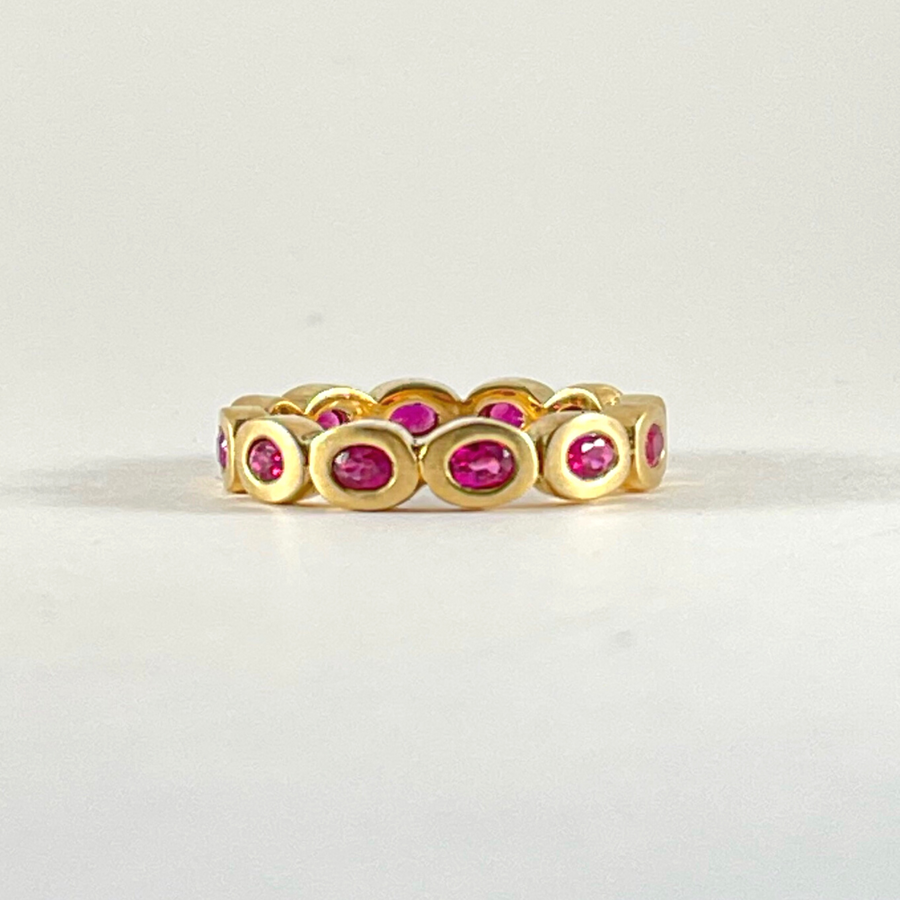 Oval Cut Ruby and Yellow Gold Eternity Ring